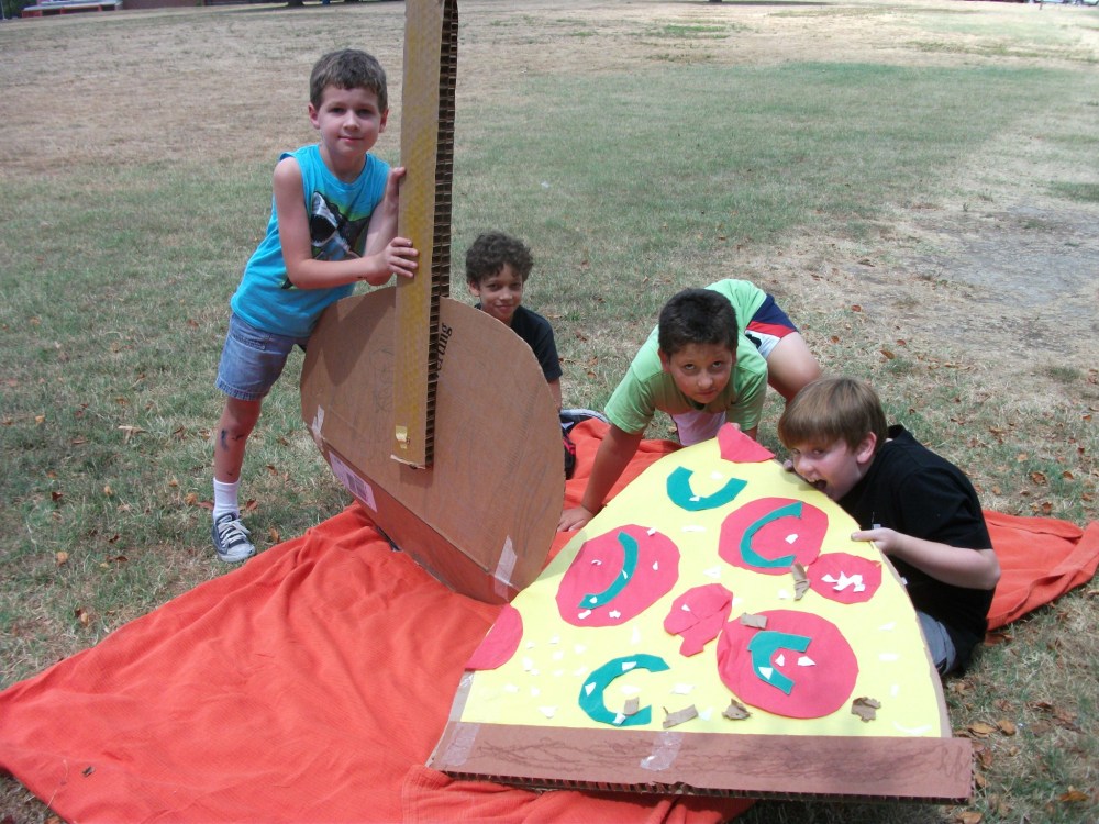 Campers eating their giant pizza